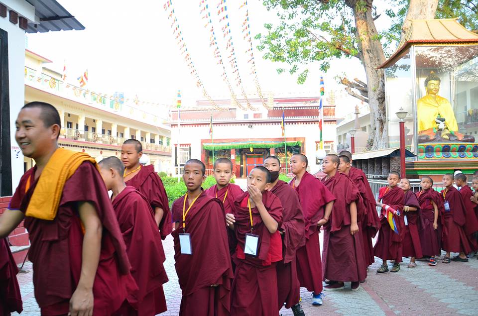 Filing through a monastery courtyard at Sarnath in the early morning.